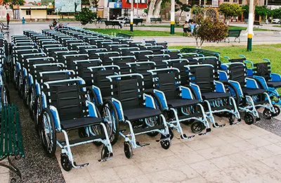 Free Wheelchair Mission impact — wheelchairs being distributed in a community
